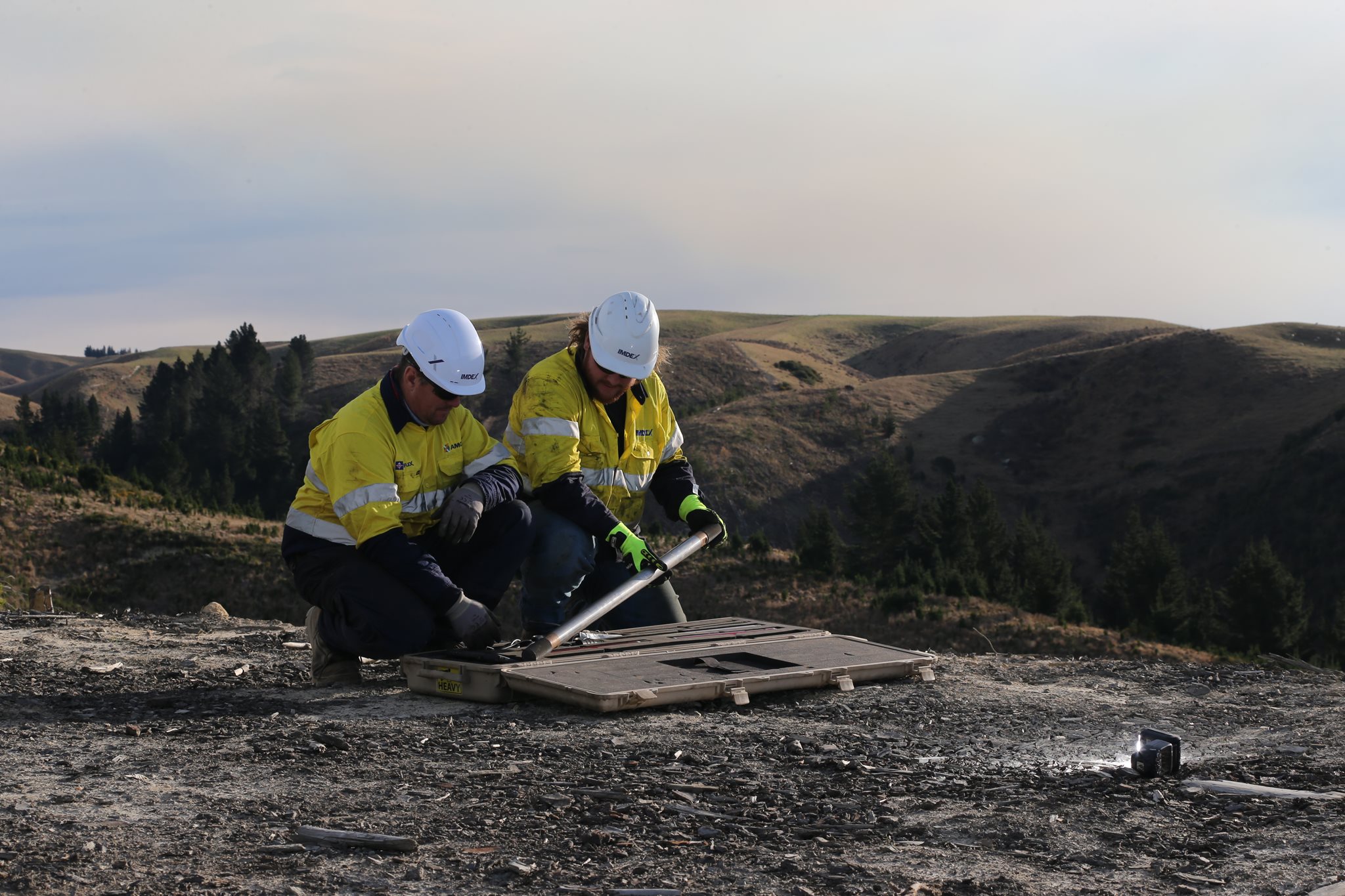 Two male drillers unpacking IMDEX rock-knowledge survey tools