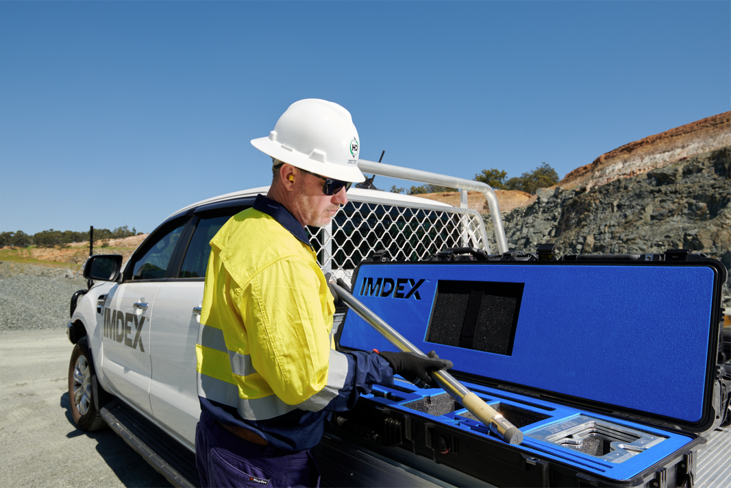 IMDEX employee holding a gyro rock-knowledge survey sensor